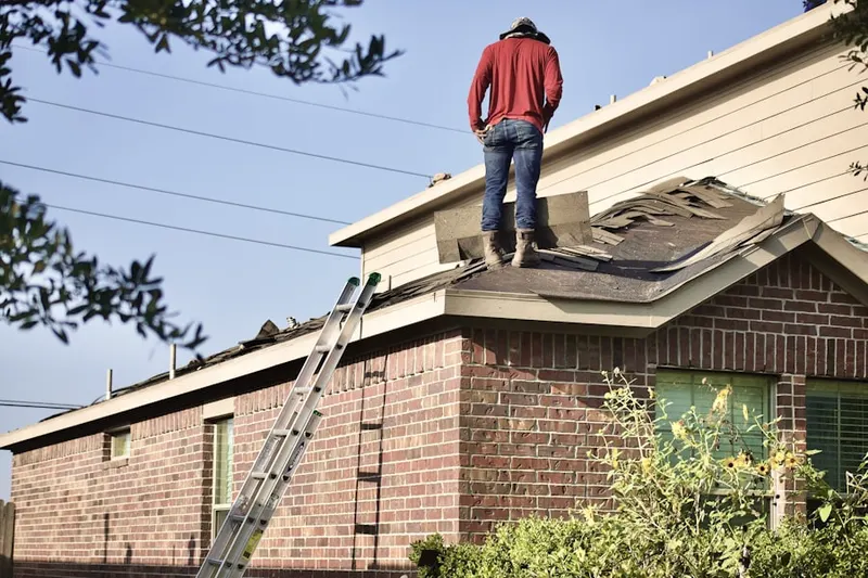 Professional roofer working on a residential roof in Hanover Center